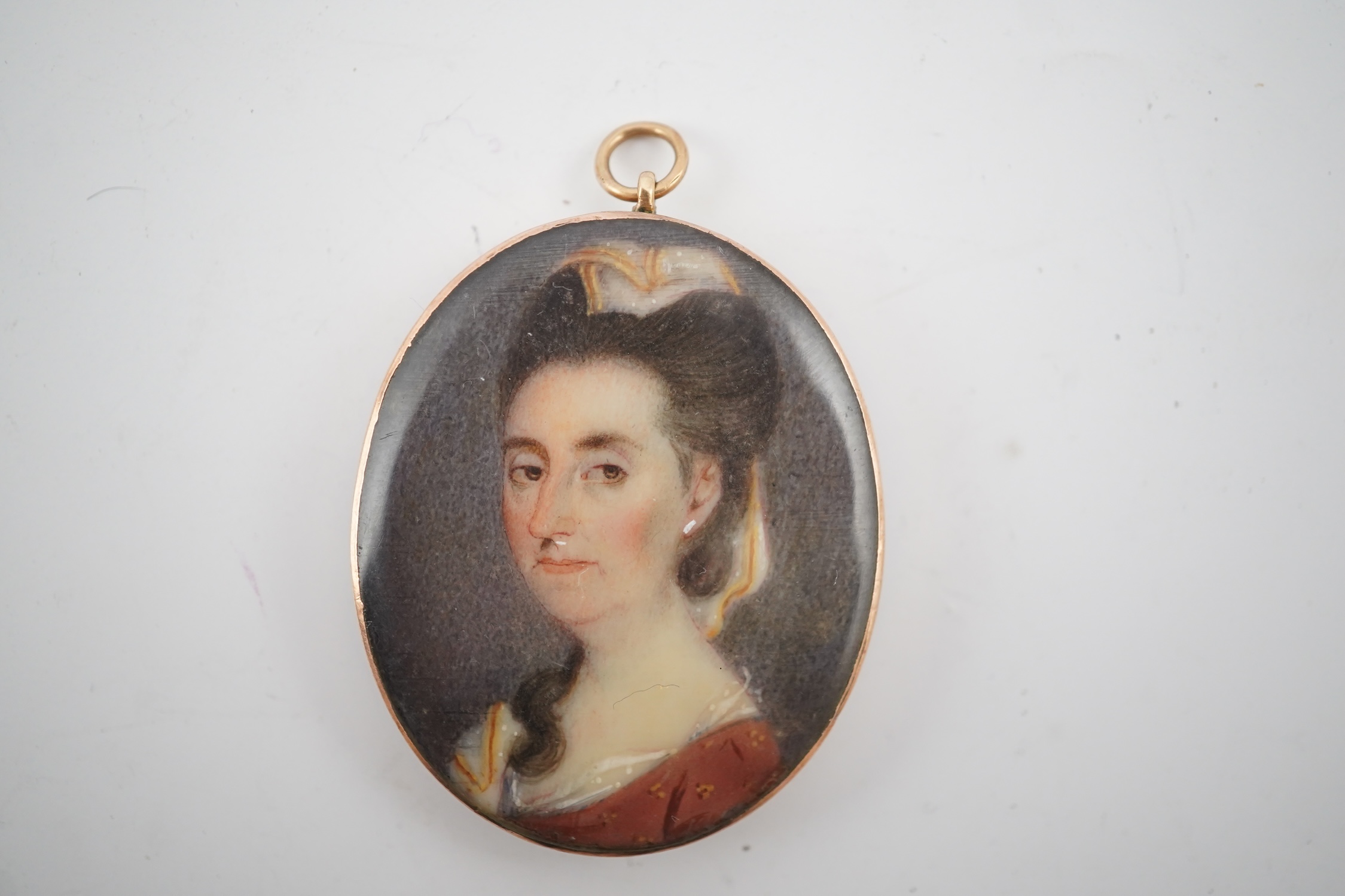 An early 19th century portrait miniature of a lady with Miers style silhouette of a gentleman verso, gold framed, 4.5cm high overall. CITES Submission reference HYCB3BFA. Condition - fair to good